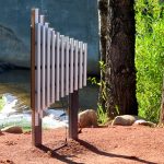 Griffen - 11 note resonated metallophone, aluminum chimes, 2 mallets, recycled plastic posts - In-Ground